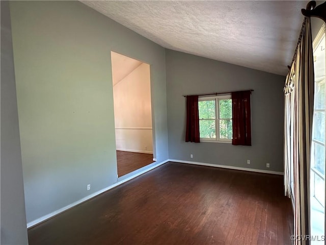 8253 Skirmish Ln, Mechanicsville, VA 23111 - empty room featuring hardwood / wood-style floors, vaulted ceiling, and a textured ceiling