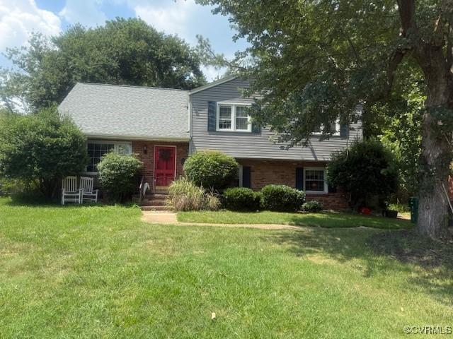 8404 Pamela Dr, Henrico, VA 23229 - split level home featuring a front yard and brick siding