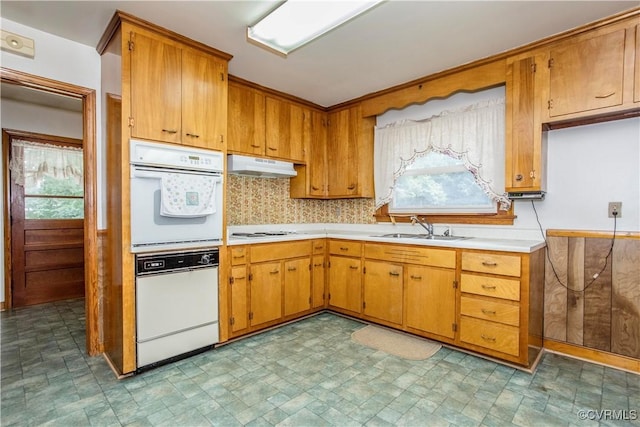 12100 Brookview Dr, Chesterfield, VA 23112 - kitchen with white appliances, under cabinet range hood, light countertops, and brown cabinetry