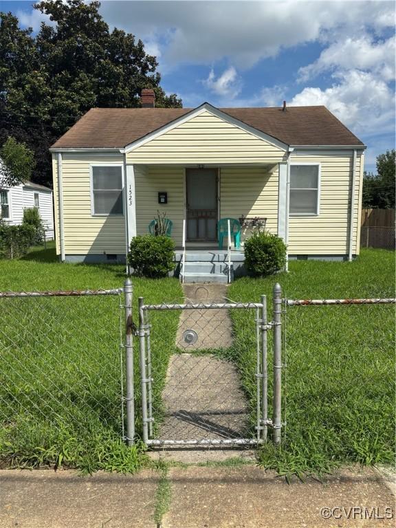 1523 N 29th, Richmond, VA 23223 - bungalow-style house with crawl space, covered porch, a fenced front yard, a gate, and a chimney