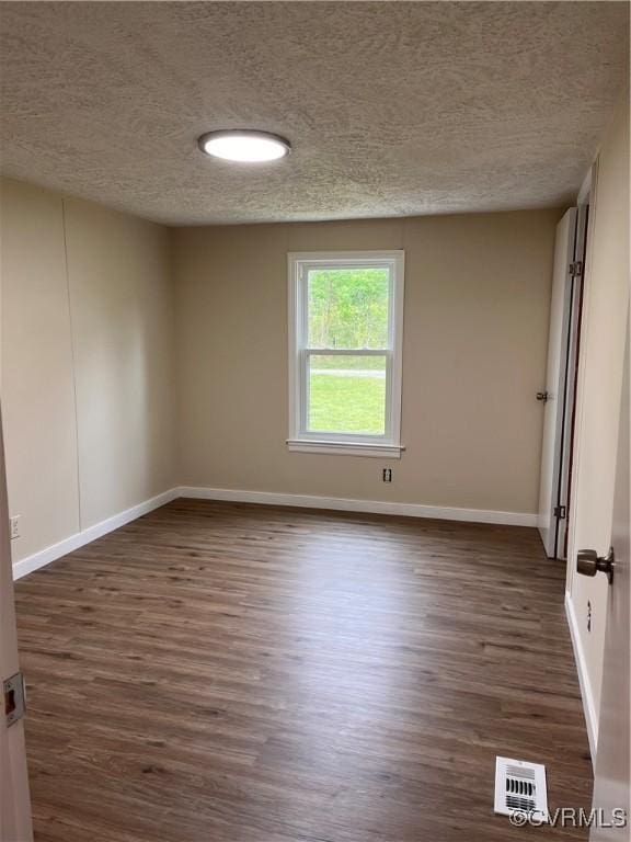 5225 Hopewell Rd, New Kent, VA 23124 - empty room featuring a textured ceiling and dark wood finished floors