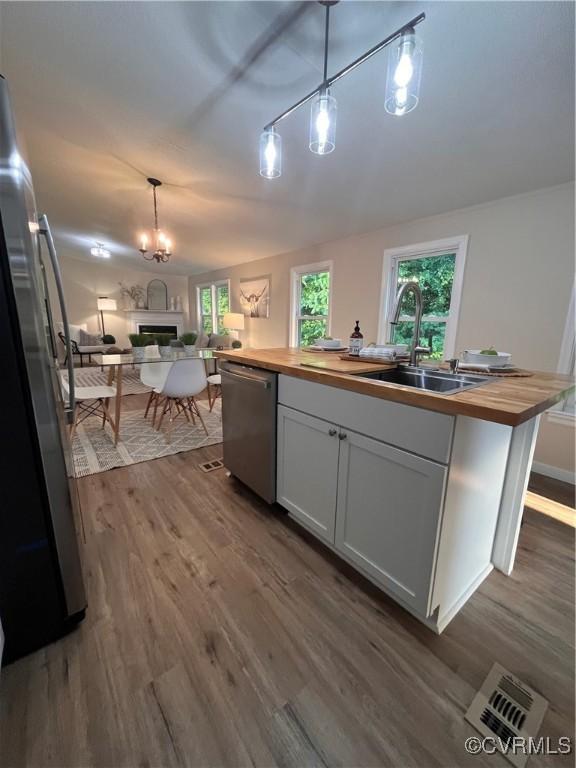 5225 Hopewell Rd, New Kent, VA 23124 - kitchen featuring wooden counters, stainless steel appliances, open floor plan, and dark wood-style floors