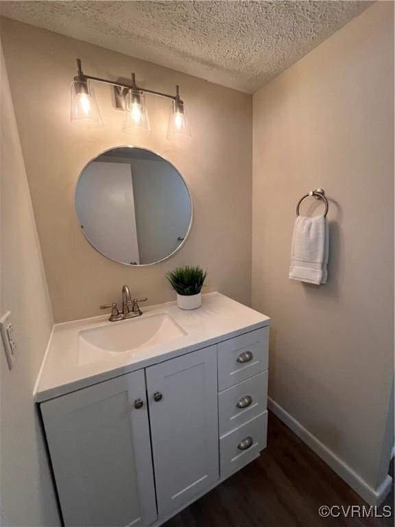 5225 Hopewell Rd, New Kent, VA 23124 - bathroom featuring a textured ceiling, wood finished floors, and vanity