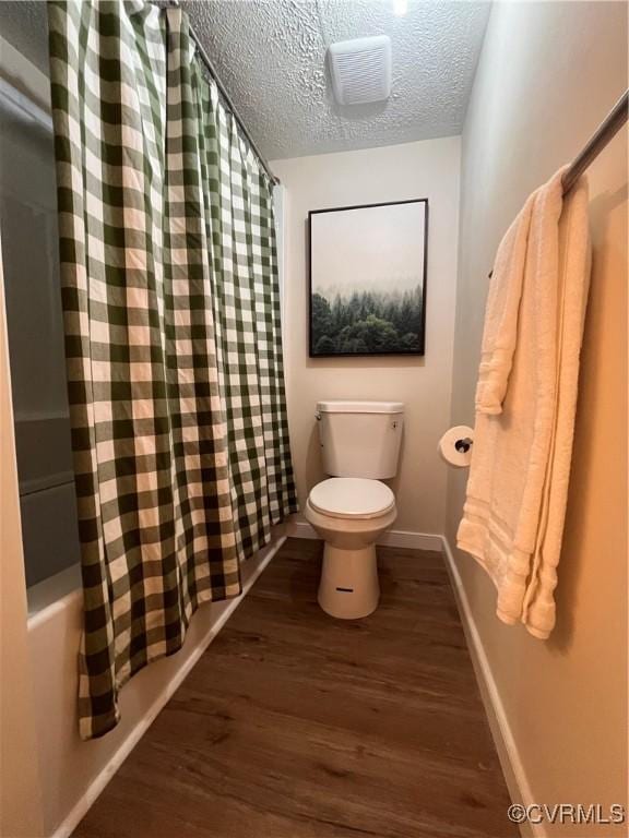 5225 Hopewell Rd, New Kent, VA 23124 - bathroom featuring wood finished floors, a textured ceiling, and shower / tub combo