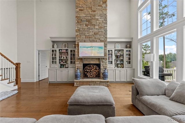 6636 Stonewolf Ct, Moseley, VA 23120 - living area featuring a towering ceiling, stairway, wood finished floors, and a fireplace