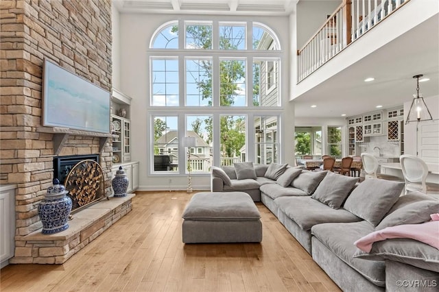 6636 Stonewolf Ct, Moseley, VA 23120 - living area featuring a towering ceiling, a stone fireplace, hardwood / wood-style floors, recessed lighting, and beamed ceiling