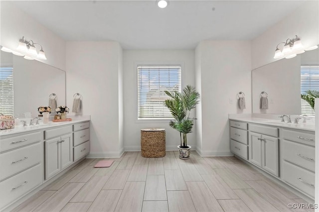 6636 Stonewolf Ct, Moseley, VA 23120 - full bathroom featuring two vanities and wood finish floors