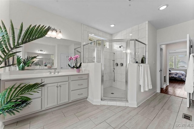 6636 Stonewolf Ct, Moseley, VA 23120 - bathroom with ensuite bathroom, vanity, a stall shower, wood finish floors, and recessed lighting