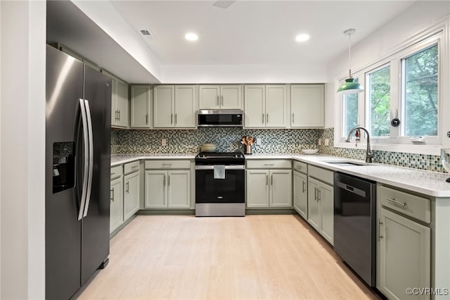 13926 Sagebrook Rd, Midlothian, VA 23112 - kitchen with appliances with stainless steel finishes, gray cabinets, light wood-style floors, light countertops, and tasteful backsplash
