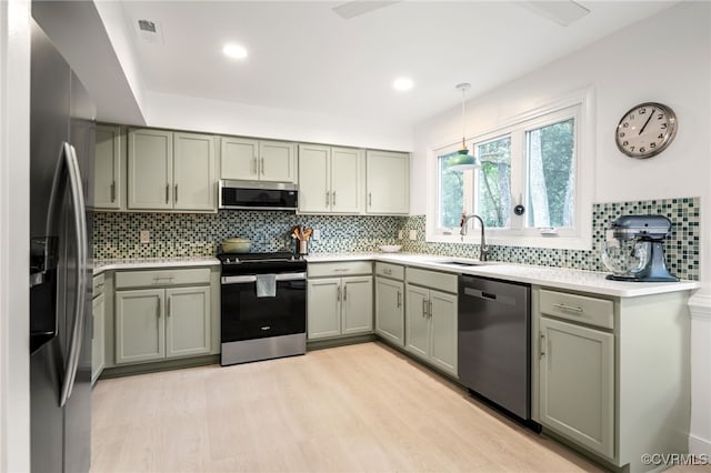 13926 Sagebrook Rd, Midlothian, VA 23112 - kitchen featuring stainless steel appliances, tasteful backsplash, gray cabinets, light wood-type flooring, and light countertops