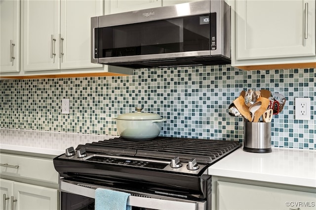 13926 Sagebrook Rd, Midlothian, VA 23112 - kitchen view of stainless steel appliances, decorative backsplash, light countertops, and white cabinets