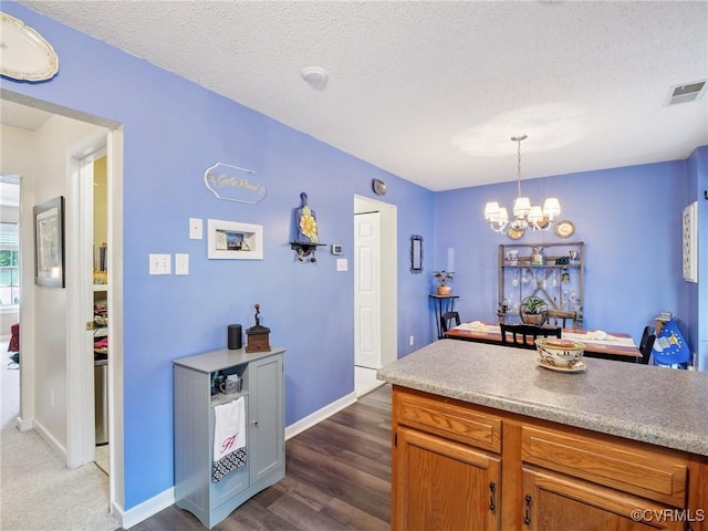 3034 Sara Jean Ter, Glen Allen, VA 23060 - kitchen with a chandelier, dark wood-style flooring, pendant lighting, light countertops, and a textured ceiling