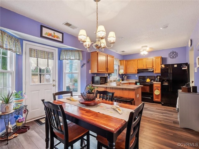3034 Sara Jean Ter, Glen Allen, VA 23060 - dining area featuring a chandelier, wood finished floors, and a textured ceiling