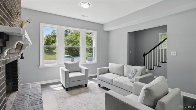1531 Berkeley Ave, Petersburg, VA 23805 - living room with a fireplace, stairway, and wood finished floors