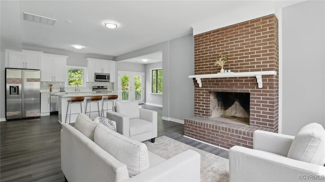 1531 Berkeley Ave, Petersburg, VA 23805 - living area with dark wood finished floors and a brick fireplace