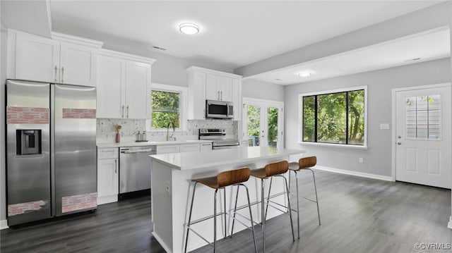 1531 Berkeley Ave, Petersburg, VA 23805 - kitchen with stainless steel appliances, dark wood finished floors, tasteful backsplash, a kitchen breakfast bar, and a center island