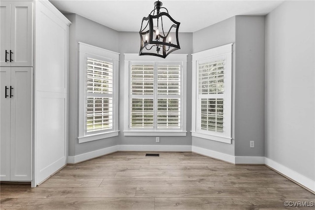 3130 Tinsley Ter, Prince George, VA 23875 - unfurnished dining area featuring light wood-type flooring and a chandelier