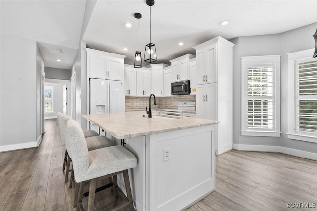 3130 Tinsley Ter, Prince George, VA 23875 - kitchen with white appliances, light wood-style flooring, white cabinets, and recessed lighting