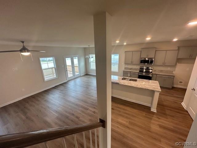 7079 Hepworth Dr, Henrico, VA 23231 - kitchen featuring appliances with stainless steel finishes, dark wood-type flooring, light stone countertops, recessed lighting, and gray cabinetry