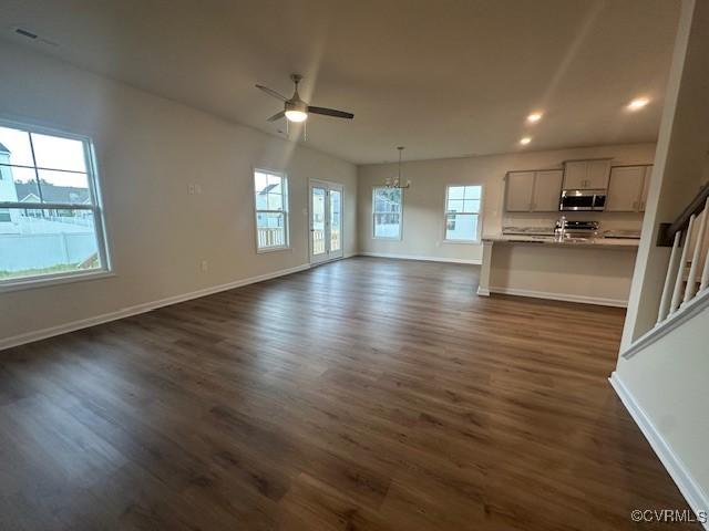 7079 Hepworth Dr, Henrico, VA 23231 - unfurnished living room featuring dark wood finished floors, ceiling fan, recessed lighting, and a chandelier