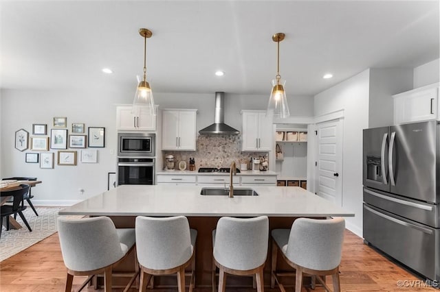 3616 Bonnies Way, Powhatan, VA 23139 - kitchen with appliances with stainless steel finishes, wall chimney range hood, light countertops, white cabinetry, and light wood-type flooring