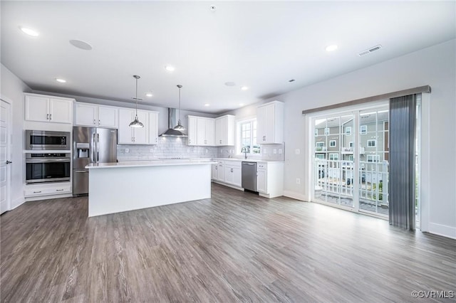 4357 Saunders Station Loop Unit B, Henrico, VA 23233 - kitchen featuring stainless steel appliances, wall chimney exhaust hood, dark wood-style flooring, white cabinets, and light countertops
