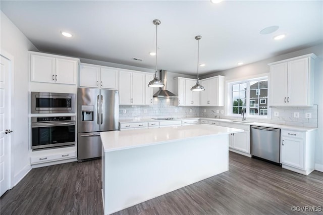 4357 Saunders Station Loop Unit B, Henrico, VA 23233 - kitchen featuring appliances with stainless steel finishes, wall chimney range hood, dark wood-style flooring, a kitchen island, and white cabinetry