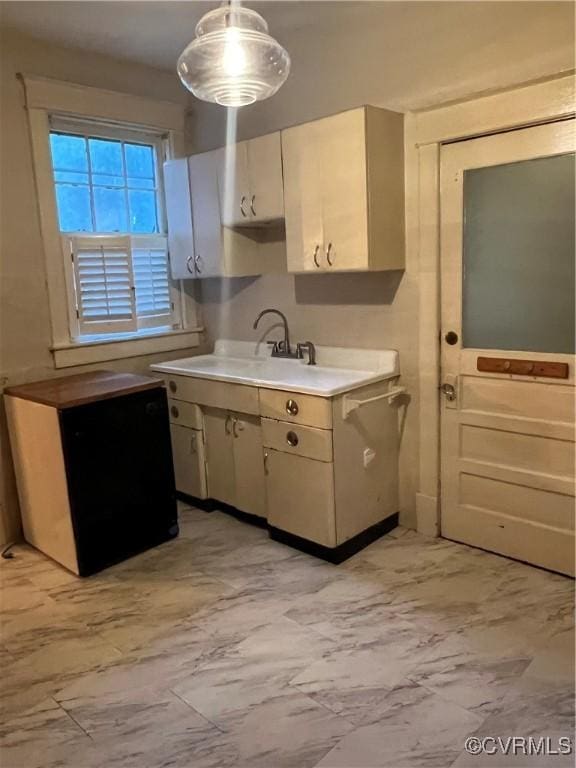 817 Lafayette Ave, Colonial Heights, VA 23834 - kitchen featuring light marble finish flooring, light countertops, and hanging light fixtures