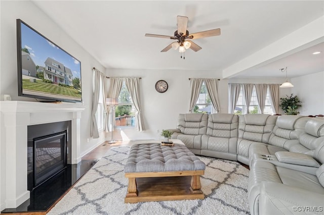 17018 Westervelt Ct, Chesterfield, VA 23120 - living room with healthy amount of natural light, ceiling fan, a glass covered fireplace, wood finished floors, and beam ceiling