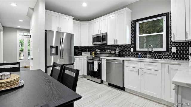 1323 Avondale Ave, Richmond, VA 23227 - kitchen with appliances with stainless steel finishes, backsplash, white cabinetry, and recessed lighting