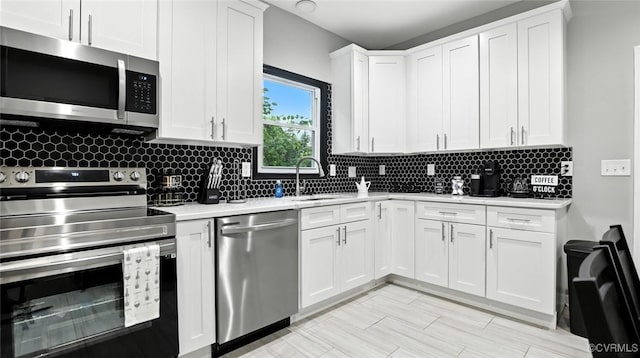 1323 Avondale Ave, Richmond, VA 23227 - kitchen with stainless steel appliances, light countertops, tasteful backsplash, and white cabinets