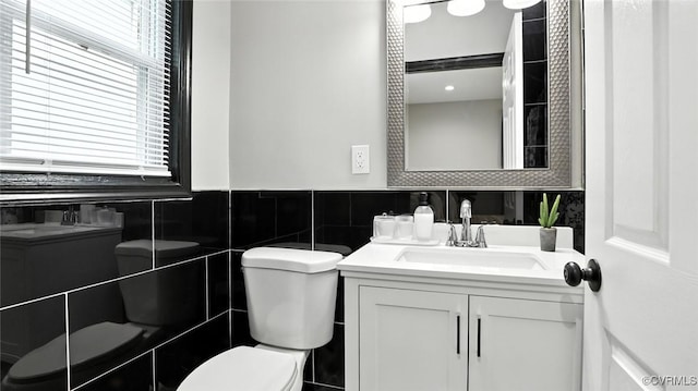 1323 Avondale Ave, Richmond, VA 23227 - bathroom with tile walls, vanity, and a wainscoted wall