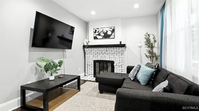 1323 Avondale Ave, Richmond, VA 23227 - living room featuring wood finished floors, a brick fireplace, and recessed lighting