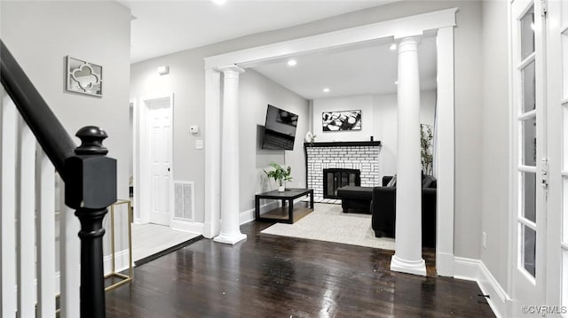 1323 Avondale Ave, Richmond, VA 23227 - foyer entrance with a fireplace, wood finished floors, stairway, and recessed lighting