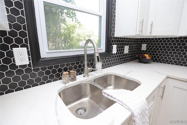 1323 Avondale Ave, Richmond, VA 23227 - kitchen view of white cabinetry, tasteful backsplash, and light stone countertops