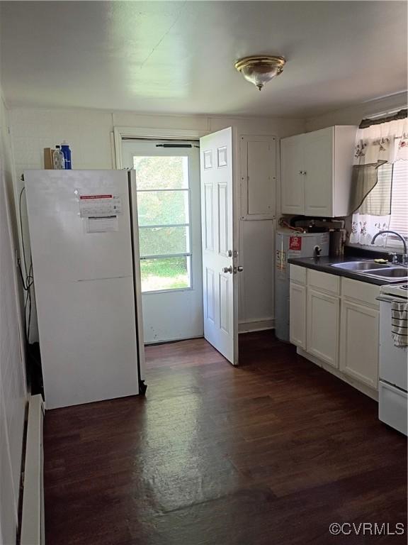 32 Seaboard St, Petersburg, VA 23803 - kitchen featuring white appliances, dark wood-style flooring, white cabinets, and dark countertops