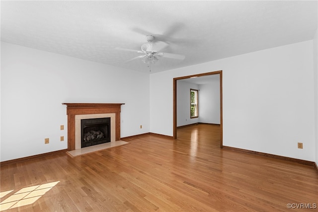 6768 Poplar Woods Ct, Quinton, VA 23141 - unfurnished living room featuring a fireplace, light wood-style floors, and a ceiling fan