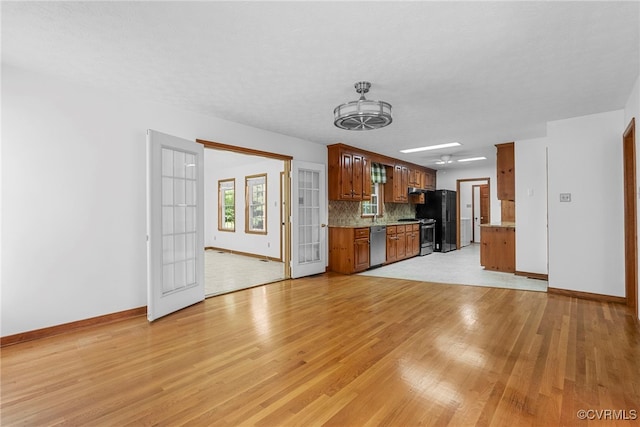 6768 Poplar Woods Ct, Quinton, VA 23141 - kitchen featuring stainless steel appliances, light wood-style flooring, backsplash, brown cabinets, and open floor plan