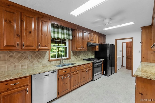 6768 Poplar Woods Ct, Quinton, VA 23141 - kitchen with appliances with stainless steel finishes, light flooring, under cabinet range hood, and brown cabinetry