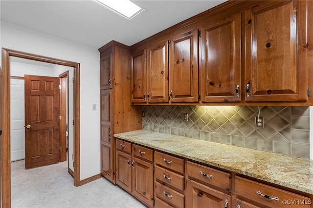 6768 Poplar Woods Ct, Quinton, VA 23141 - kitchen featuring backsplash, light stone countertops, and brown cabinetry