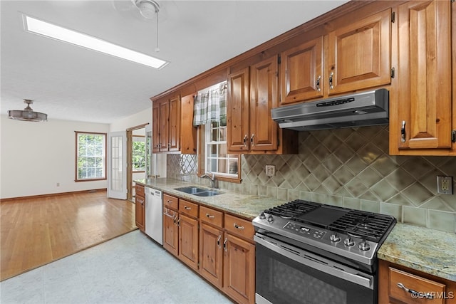 6768 Poplar Woods Ct, Quinton, VA 23141 - kitchen with stainless steel appliances, under cabinet range hood, light stone counters, and brown cabinetry
