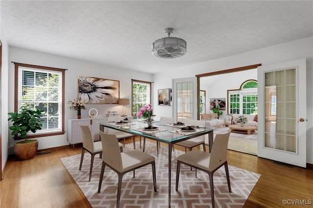 6768 Poplar Woods Ct, Quinton, VA 23141 - dining room featuring light wood-type flooring and a textured ceiling