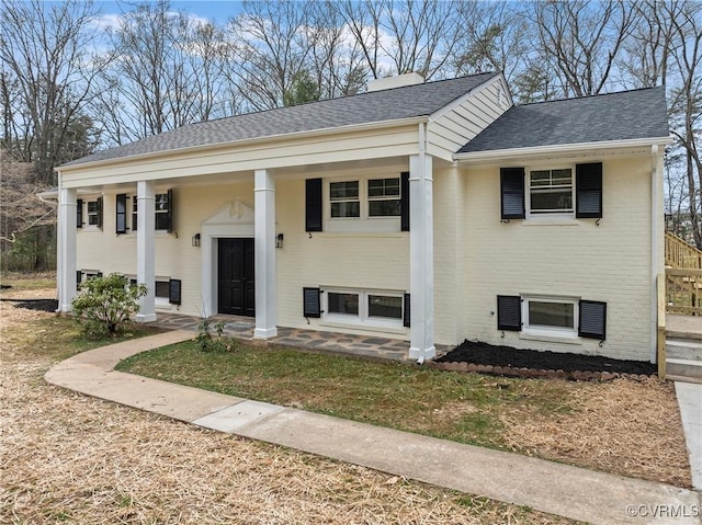 4029 Old Buckingham Rd, Powhatan, VA 23139 - bi-level home with roof with shingles, a porch, and brick siding