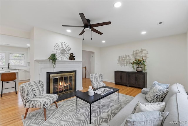 4029 Old Buckingham Rd, Powhatan, VA 23139 - living room with ceiling fan, a fireplace with flush hearth, recessed lighting, and light wood-type flooring