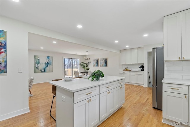 4029 Old Buckingham Rd, Powhatan, VA 23139 - kitchen featuring freestanding refrigerator, light wood finished floors, white cabinetry, decorative backsplash, and recessed lighting