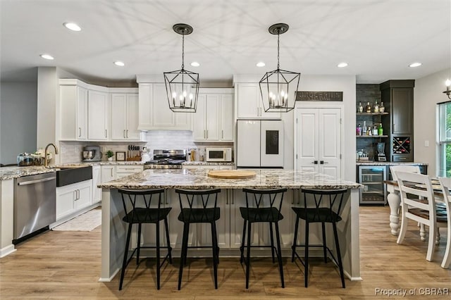 4217 Pillar, Williamsburg, VA 23188 - kitchen with stainless steel appliances, beverage cooler, decorative backsplash, recessed lighting, and a kitchen island