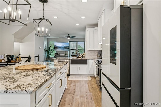 4217 Pillar, Williamsburg, VA 23188 - kitchen with appliances with stainless steel finishes, recessed lighting, white cabinetry, a chandelier, and light wood finished floors