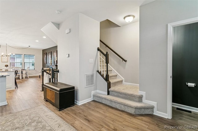 4217 Pillar, Williamsburg, VA 23188 - stairway featuring wood finished floors, a chandelier, and recessed lighting