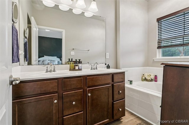 4217 Pillar, Williamsburg, VA 23188 - full bathroom with ensuite bath, double vanity, a bath, and wood finished floors