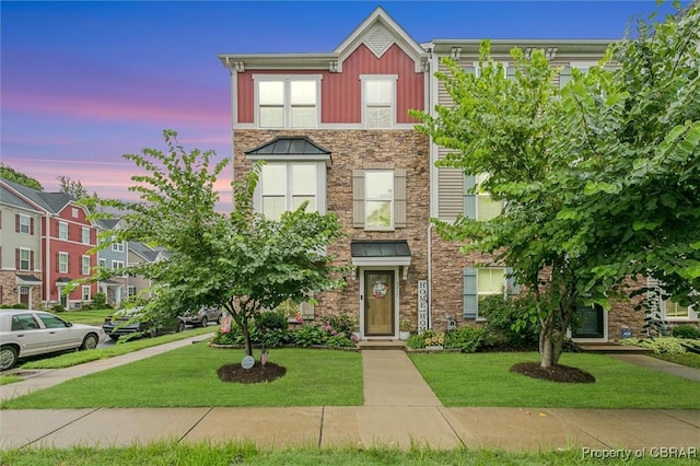 4217 Pillar, Williamsburg, VA 23188 - townhome / multi-family property featuring stone siding, a lawn, and board and batten siding